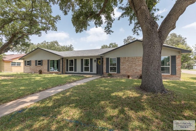 1409 Pine Ct, Harlingen, TX 78550 - ranch-style house featuring brick siding and a front yard