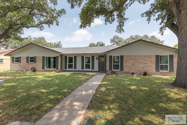 1409 Pine Ct, Harlingen, TX 78550 - ranch-style house featuring brick siding and a front yard