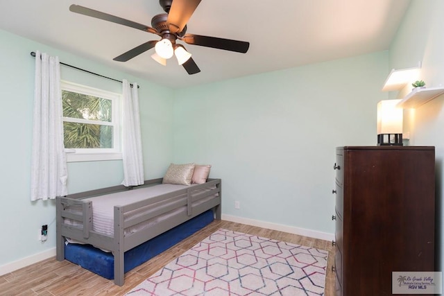 1409 Pine Ct, Harlingen, TX 78550 - bedroom with light wood finished floors, baseboards, and a ceiling fan