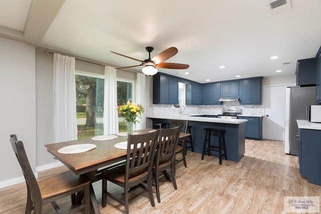 1409 Pine Ct, Harlingen, TX 78550 - dining room with light wood-style flooring, a ceiling fan, and recessed lighting