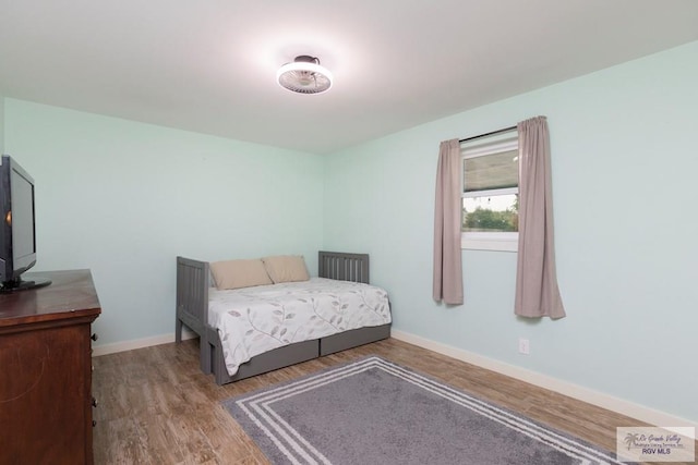 1409 Pine Ct, Harlingen, TX 78550 - bedroom featuring wood finished floors and baseboards