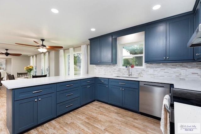 1409 Pine Ct, Harlingen, TX 78550 - kitchen with dishwasher, a peninsula, electric range, a sink, and light countertops