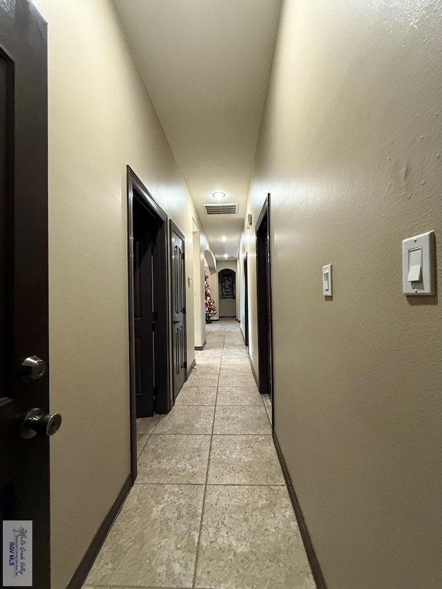 corridor featuring visible vents and baseboards