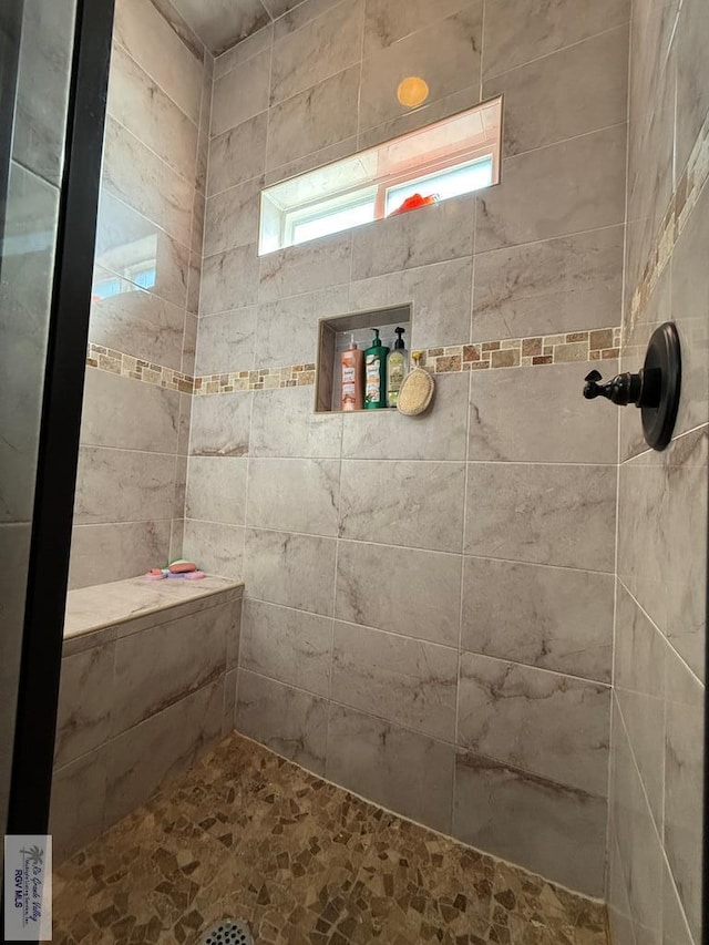 bathroom with a tile shower