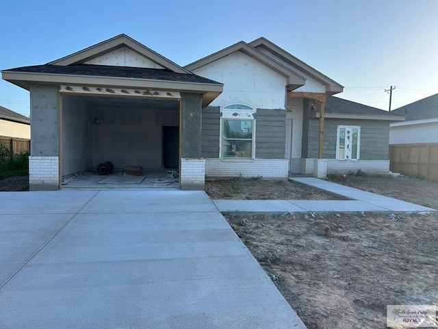 32711 Jorge St, Los Fresnos, TX 78566 - view of front facade with driveway, brick siding, and an attached garage