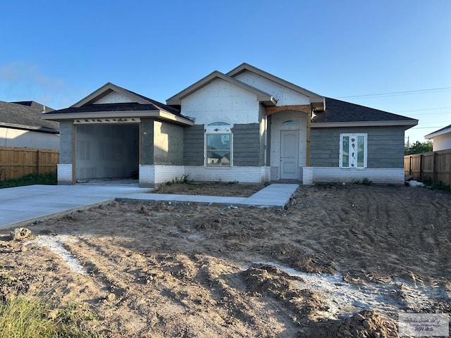 32711 Jorge St, Los Fresnos, TX 78566 - property in mid-construction featuring brick siding, an attached garage, and driveway
