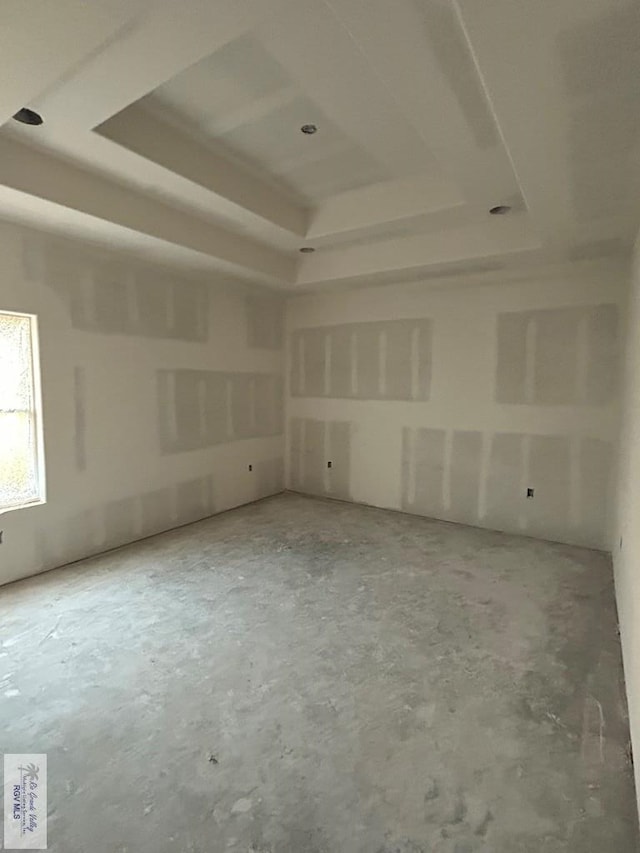 32711 Jorge St, Los Fresnos, TX 78566 - unfurnished room featuring a raised ceiling and unfinished concrete floors