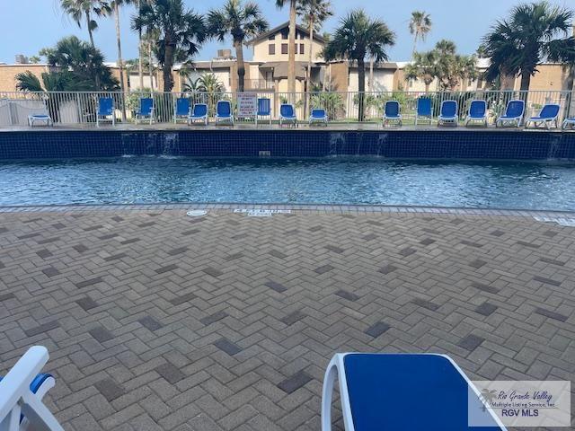 1000 Padre Blvd Unit 307, South Padre Island, TX 78597 - view of swimming pool featuring fence