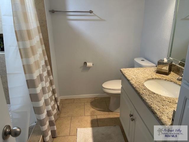1000 Padre Blvd Unit 307, South Padre Island, TX 78597 - full bath with toilet, tile patterned floors, vanity, a shower with shower curtain, and baseboards