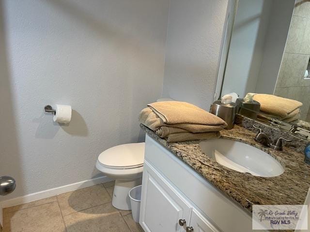 1000 Padre Blvd Unit 307, South Padre Island, TX 78597 - bathroom with toilet, vanity, tile patterned floors, and baseboards
