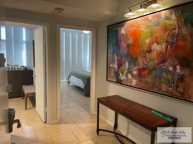 1000 Padre Blvd Unit 307, South Padre Island, TX 78597 - corridor featuring light tile patterned floors and baseboards
