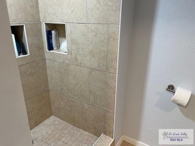 1000 Padre Blvd Unit 307, South Padre Island, TX 78597 - full bath featuring a tile shower and baseboards