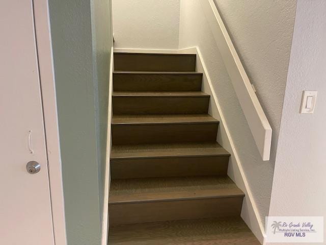 1000 Padre Blvd Unit 307, South Padre Island, TX 78597 - staircase with a textured wall