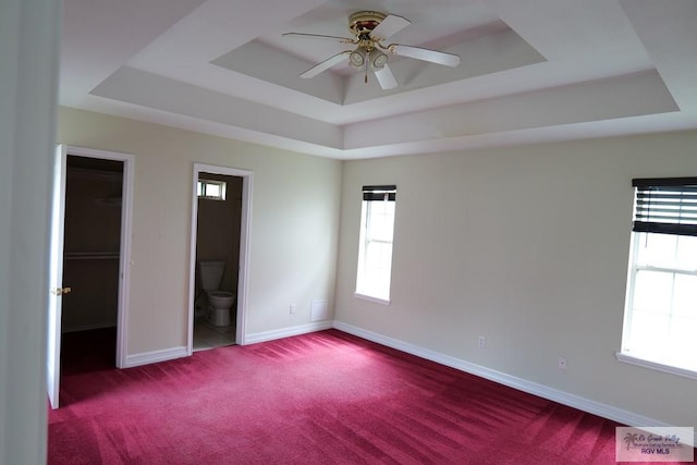 487 Agua Viva Ln, Brownsville, TX 78521 - unfurnished bedroom with a raised ceiling, carpet, baseboards, and connected bathroom