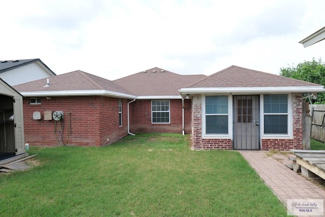 487 Agua Viva Ln, Brownsville, TX 78521 - back of house featuring brick siding and a shingled roof