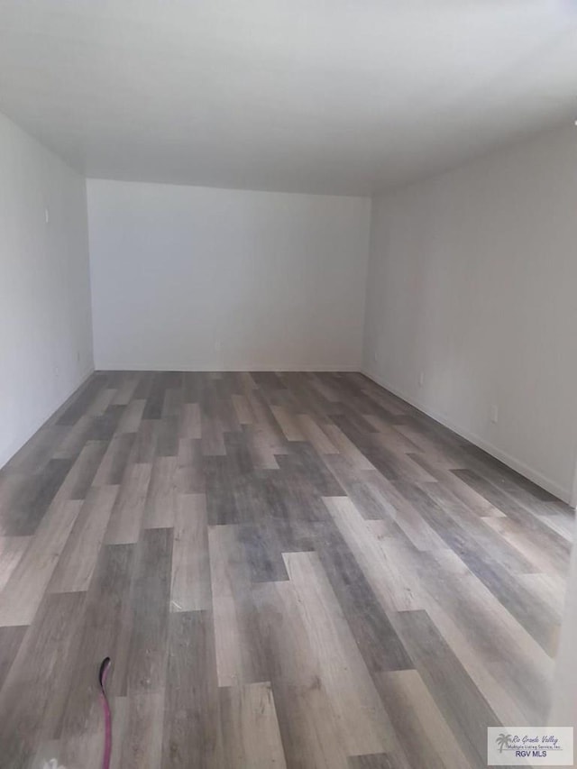 spare room with wood finished floors