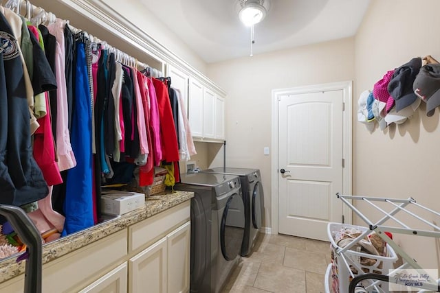 laundry room with cabinets, washer and clothes dryer, and light tile patterned flooring