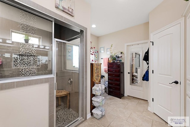 bathroom featuring tile patterned flooring and an enclosed shower