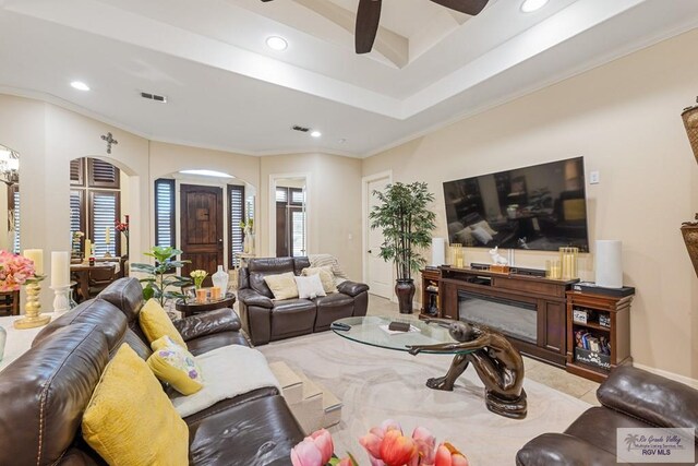 living room with ceiling fan and crown molding