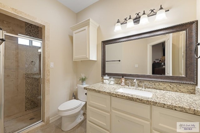 bathroom with a shower with door, vanity, and toilet