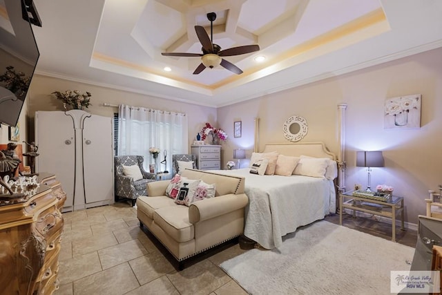 bedroom with a tray ceiling, ceiling fan, and ornamental molding