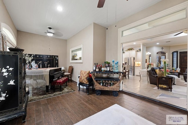 living room featuring wood-type flooring and ceiling fan