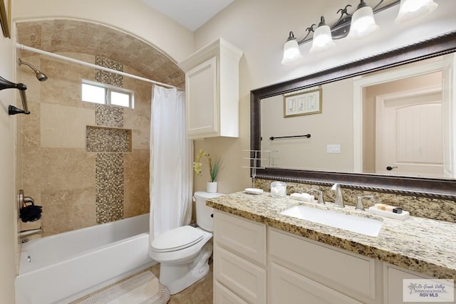 full bathroom with shower / tub combo with curtain, vanity, and toilet