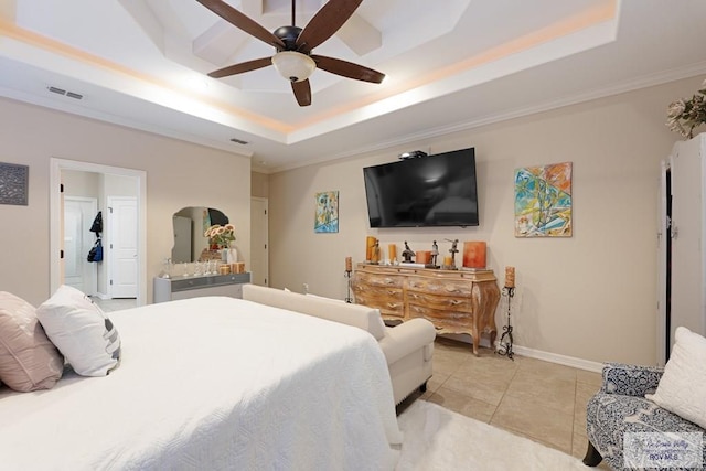 tiled bedroom featuring ceiling fan and a tray ceiling