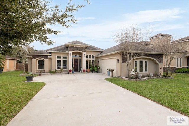 mediterranean / spanish home with a front yard and a garage