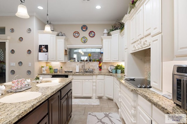 kitchen featuring backsplash, white cabinetry, crown molding, and sink