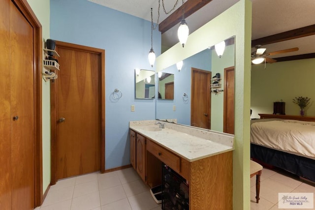 bathroom with ceiling fan, vanity, and beamed ceiling