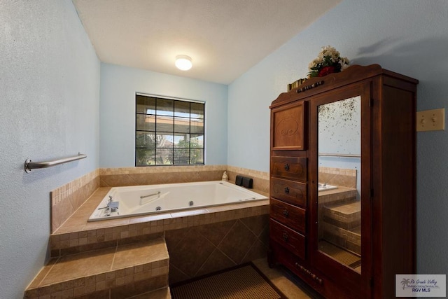 bathroom with tile patterned floors and tiled tub