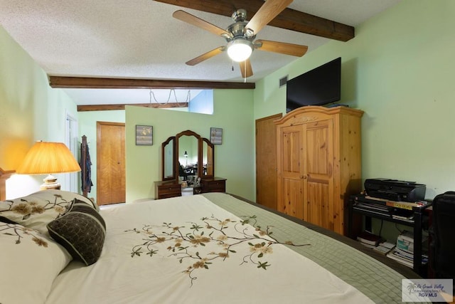 bedroom featuring a textured ceiling, ceiling fan, and beamed ceiling