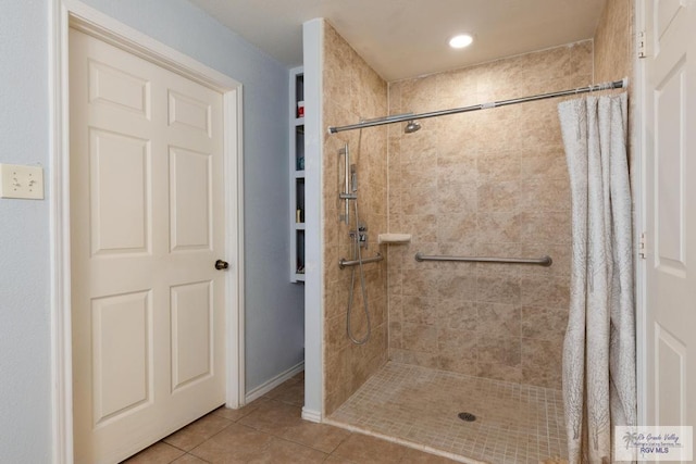 bathroom with walk in shower and tile patterned floors