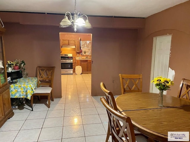 1770 Palmas Verdes Ct, Brownsville, TX 78520 - dining area featuring light tile patterned flooring and a chandelier