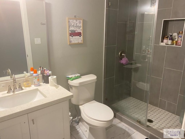 bathroom featuring toilet, vanity, a shower stall, and marble finish floor