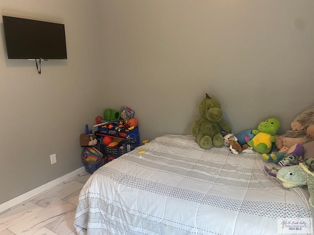 bedroom with marble finish floor and baseboards