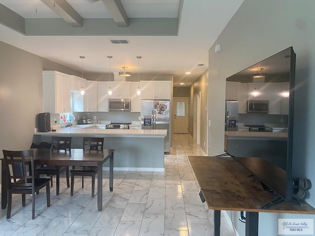 kitchen featuring a sink, appliances with stainless steel finishes, visible vents, a peninsula, and marble finish floor
