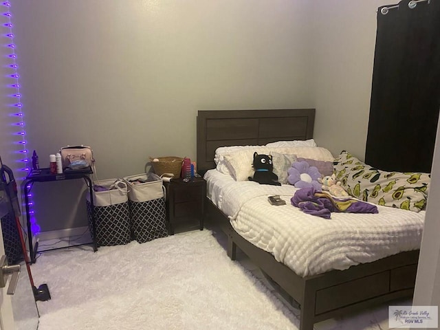 bedroom featuring light colored carpet