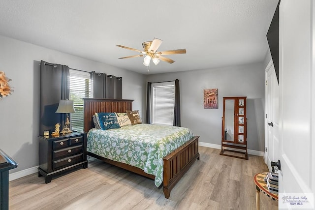 bedroom featuring light wood-type flooring, ceiling fan, and baseboards