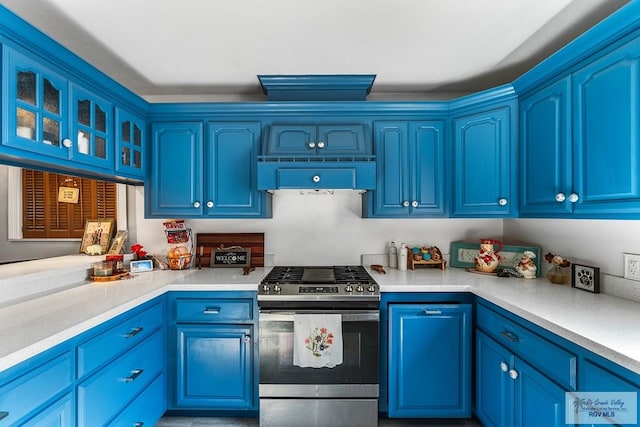 kitchen featuring blue cabinetry and stainless steel range with gas cooktop