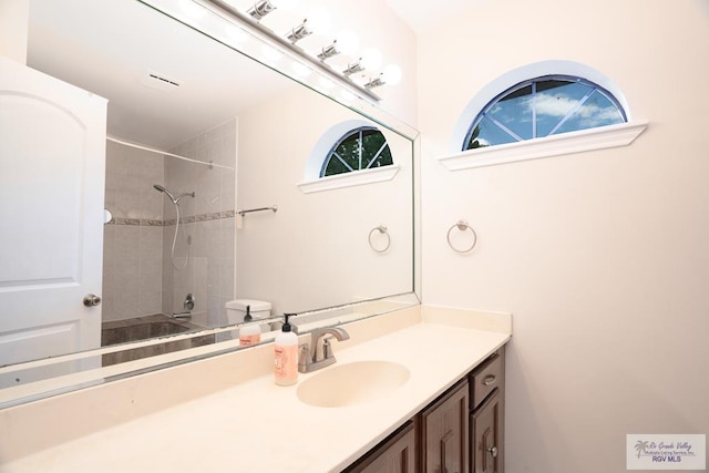 bathroom with vanity and tiled shower / bath combo