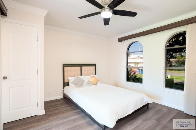 bedroom featuring ornamental molding, ceiling fan, and dark wood-type flooring