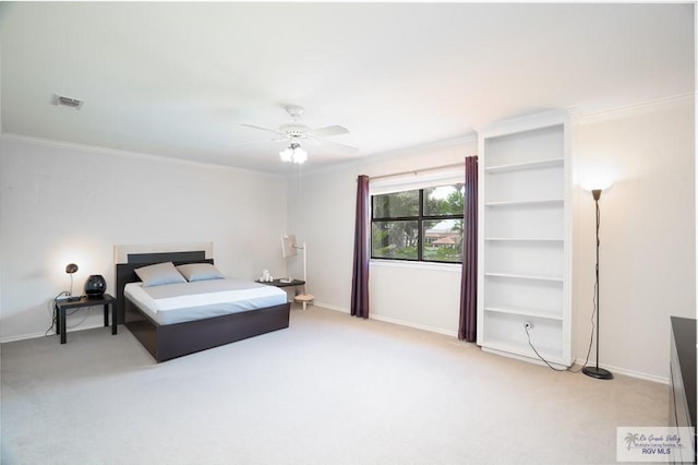 carpeted bedroom with ceiling fan and ornamental molding