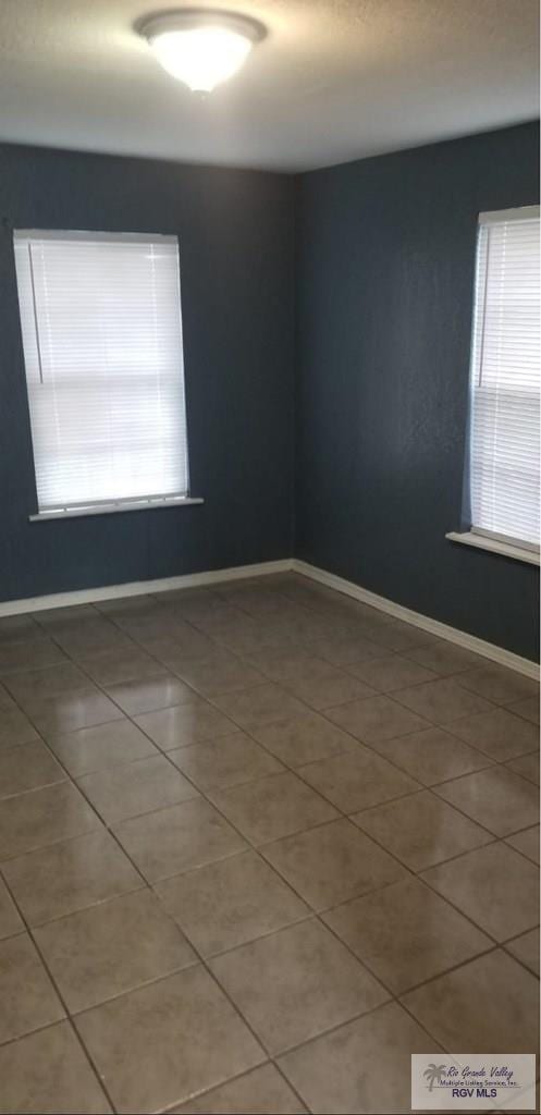 tiled spare room with baseboards