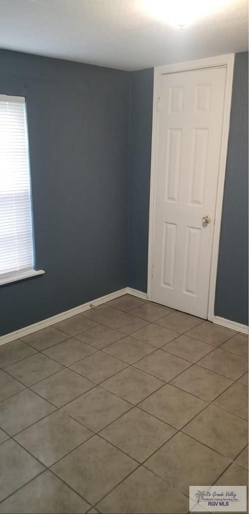 empty room featuring baseboards