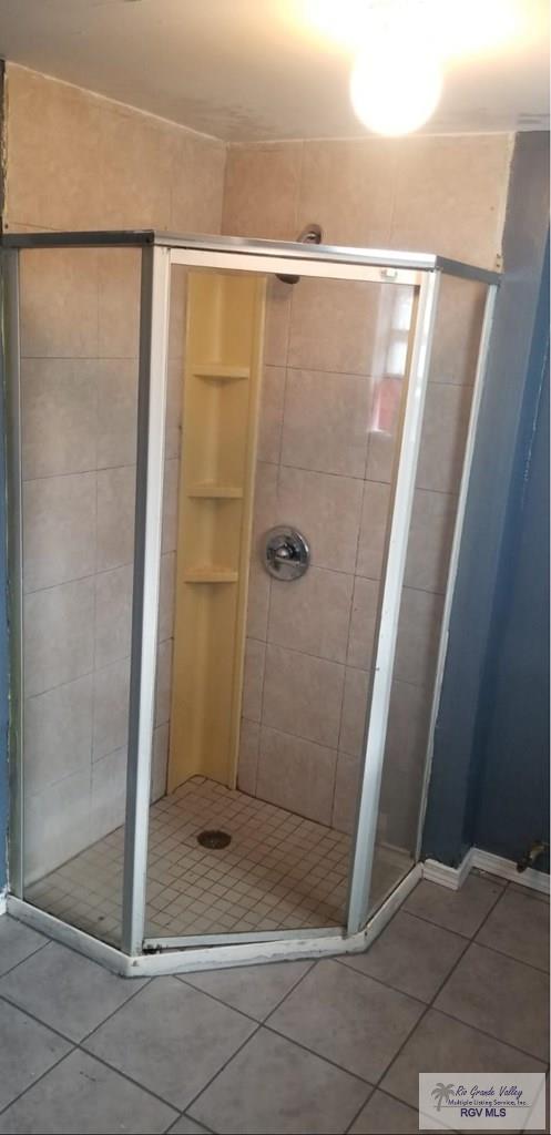 bathroom featuring a stall shower and tile patterned floors