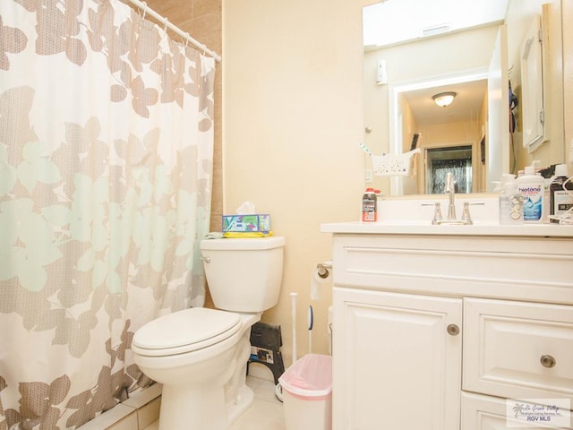 3104 Buckingham Ct, Brownsville, TX 78526 - full bath featuring toilet, vanity, tile patterned floors, and a shower with curtain