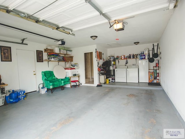 3104 Buckingham Ct, Brownsville, TX 78526 - garage with separate washer and dryer, a garage door opener, water heater, and refrigerator