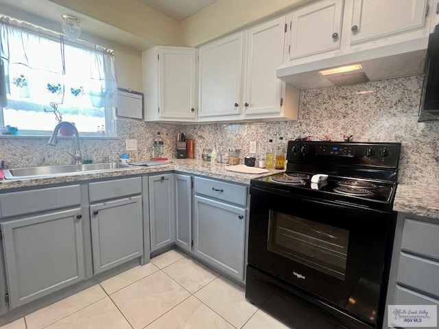 3104 Buckingham Ct, Brownsville, TX 78526 - kitchen featuring black / electric stove, gray cabinets, under cabinet range hood, a sink, and decorative backsplash